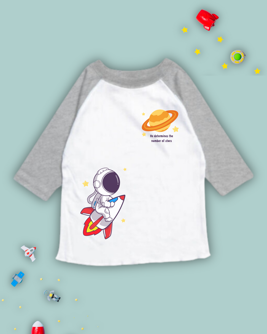 christian raglan tshirts for kids that has an astronaut, rocketship, planet, stars and bible verse from Psalm 147