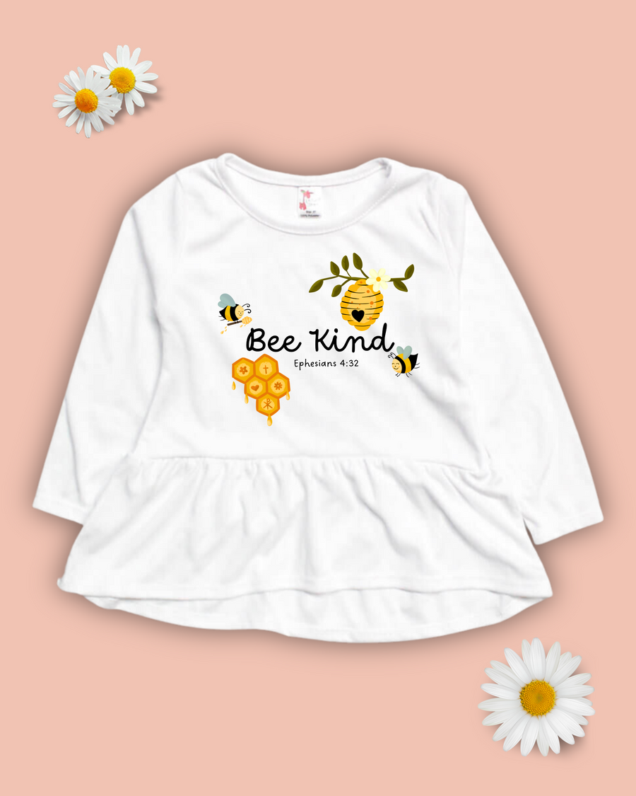 Long sleeve christian kids apparel girls peplum top with the words 'Bee Kind' surrounded by cute bees, a bee hive, honeycomb and the bible verse Ephesians 4:32