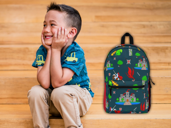 little boy sitting on school bleachers next to his Christian themed backpack