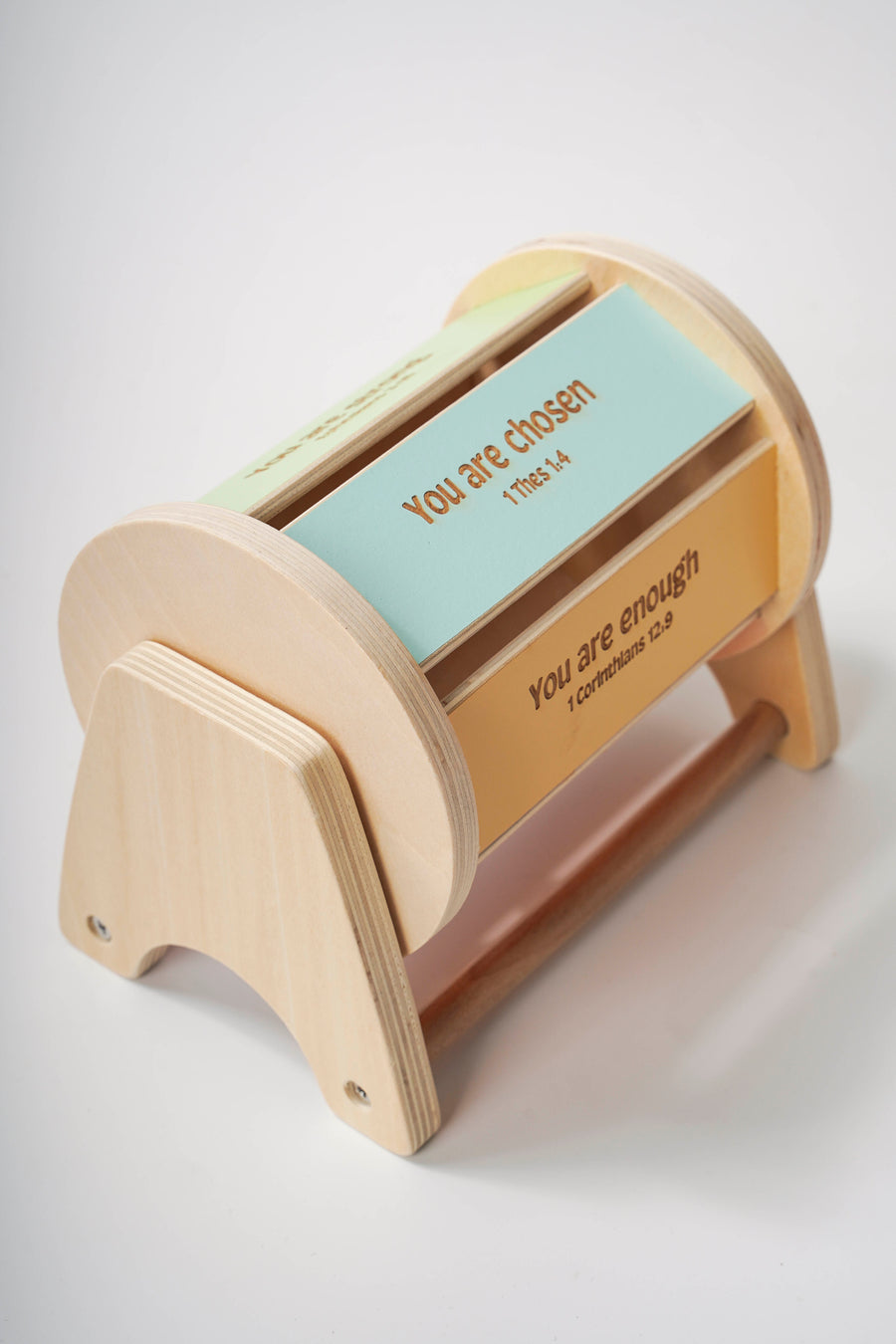 Montessori inspired wooden spinning drum where each panel on the drum features an affirmation bible verse. 'You are chosen' is pictured.